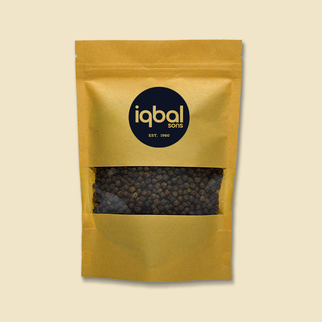Gold packaging of black peppercorns with 'iqbal sons' logo on a beige background
