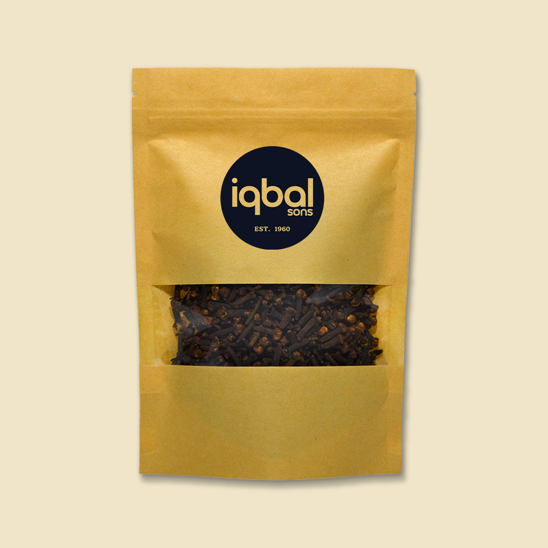 Gold packaging of Iqbal Sons Cloves with on a beige background