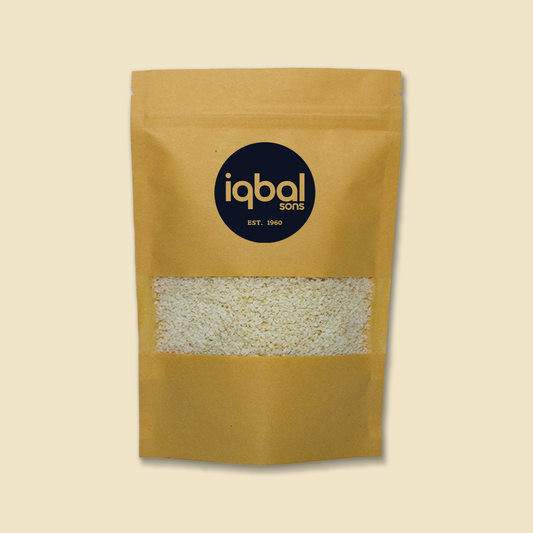 Kraft paper bag with 'iqbal sons' branding on a beige background